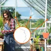 A woman working in a greenhouse, with a close-up inset of greenhouse clips. Produktbild-Vorschau