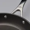 A close-up view of a frying pan handle and rim. Náhľad obrázku produktu