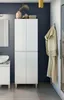 A bathroom with a tall white cabinet, a sink, and a bathrobe hanging on the wall. Produktbild-Vorschau