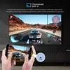 A television screen displays a racing game, with a smartphone in the foreground mirroring the game and showing a 'Cast' icon. Produktbild-Vorschau