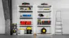 Two metal shelving units filled with various tools and storage containers, with a pressure washer and a ladder nearby. Náhled obrázku produktu