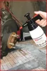 A hand is holding a spray bottle near a car's brake assembly. Podgląd zdjęcia produktu