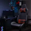 A gaming chair and desk setup in a dimly lit room. Produktbild-Vorschau