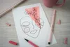 A flat lay of art supplies and a notebook. Produktbild-Vorschau