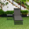 A sun lounger and side table are set up on a green lawn next to a white staircase and lush green plants. Náhled obrázku produktu