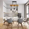 A dining room with a modern chandelier over a table and chairs. Náhľad obrázku produktu