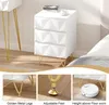 A white nightstand with gold legs, shown from different angles and with close-ups of its features. Produktbild-Vorschau