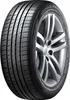 A close-up studio shot of a car tire mounted on a silver alloy wheel, isolated on a white background. Podgląd zdjęcia produktu