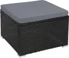 A black rattan ottoman with a gray cushion on a white background. Produktbild-Vorschau