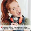A woman with red hair, wearing headphones and overalls, is enthusiastically holding a cordless drill as if it were a microphone. She is winking and has her mouth open in a shout or song. A red checkmark and text are present at the bottom of the image. Produktbild-Vorschau