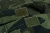 A close-up view of two velcro patches on a camouflage fabric. Náhled obrázku produktu