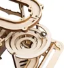 A close-up view of a wooden marble run toy with a metal ball on a track. Produktbild-Vorschau