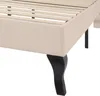 A close-up view of the corner of a bed frame, showing the upholstered side and one of the decorative legs. Produktbild-Vorschau