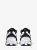 A pair of white Nike Air Monarch IV sneakers shown from the back. Produktbild-Vorschau