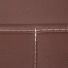 A close-up view of brown faux leather with white stitching. Náhled obrázku produktu