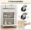 A white kitchen cart with a wooden top is shown, featuring various bottles and a vase inside. The image also includes close-ups of the cart's wheels and a hand demonstrating a feature. Podgląd zdjęcia produktu