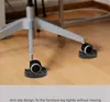 Close-up of chair casters with anti-slip pads on a wooden floor. Podgląd zdjęcia produktu