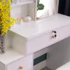 A white vanity table with drawers and a mirror, decorated with yellow flowers. Voir les images du produit