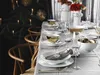 A beautifully set dining table with Christmas decorations, including candles and straw stars, suggesting a festive occasion. Anteprima dell’immagine prodotto