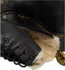 A close-up view of the inside of a black leather boot, showing the fur lining and laces. Anteprima dell’immagine prodotto