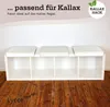 A white Kallax shelf unit with three white cushions on top, placed against a white wall. Produktbild-Vorschau