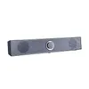 A dark gray computer soundbar with a textured front grille and a silver control knob in the center, isolated on a white background. Voir les images du produit