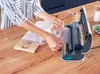 A person is using a vacuum sealer to seal food in a plastic bag on a wooden table. Náhľad obrázku produktu