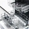 The interior of a dishwasher with racks and glasses. Produktbild-Vorschau