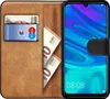 A book-style phone case with a phone inserted, showing cards and banknotes inside. Anteprima dell’immagine prodotto