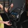 A person's hands are shown interacting with the console of a TREX SPORT Crosstrainer. Produktbild-Vorschau