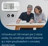 A couple is sitting at a table, with the man using a blood pressure monitor. The monitor is also shown in a close-up view with icons. Produktbild-Vorschau