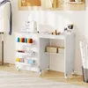 A white sewing table with various sewing supplies is shown in a well-lit room. Náhled obrázku produktu