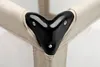 A close-up view of a black plastic corner protector on a beige fabric structure, likely part of a baby playpen or similar item. Produktbild-Vorschau