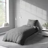 A bedroom scene with a bed, lamp, and window. Produktbild-Vorschau