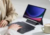 A person is using a tablet with a keyboard case, with a coffee cup on the side. Produktbild-Vorschau