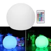 A collage showing a white LED globe light and a remote control, with two smaller images below showing the light in blue and green hues in a dimly lit setting with glasses. Podgląd zdjęcia produktu