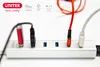 A close-up shot of a silver USB hub with multiple ports, showing various USB devices and cables plugged in. Voir les images du produit
