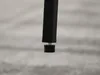 Close-up of the bottom of a black table leg with an adjustable foot. Voir les images du produit
