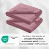 Two folded pink knitted baby blankets are shown with a certification logo and descriptive text. Produktbild-Vorschau