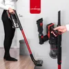 A person is using a cordless vacuum cleaner on a wooden floor, while another image shows the vacuum cleaner mounted on a wall charger with attachments. Voir les images du produit