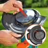 A close-up shot of a person's hands holding and demonstrating a part of a lawn trimmer, with an inset circular view showing a detail of the trimmer head. Produktbild-Vorschau