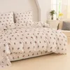 A bed with floral patterned bedding. Produktbild-Vorschau