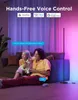A couple is playing video games in a living room, with a floor lamp in the background emitting colored light. Podgląd zdjęcia produktu