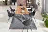 A dining room scene with a wooden table and chairs. Produktbild-Vorschau