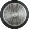 The underside of a black frying pan with a textured metallic base. Anteprima dell’immagine prodotto