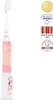 A pink and white electric toothbrush with cartoon cow decoration, placed on a white background with several award badges and text overlays. Náhled obrázku produktu