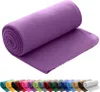 A rolled-up purple fleece blanket is shown in the foreground, with a row of other rolled blankets in various colors in the background. Náhľad obrázku produktu