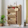 A wooden shoe cabinet with rattan doors and a drawer, placed in a room with a plant and curtains. Podgląd zdjęcia produktu