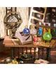 A miniature magical laboratory setup with a globe, books, potions, and a crystal ball on a wooden table. Náhled obrázku produktu