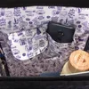 The interior of a backpack with a travel-themed pattern and a phone in a pocket. Anteprima dell’immagine prodotto